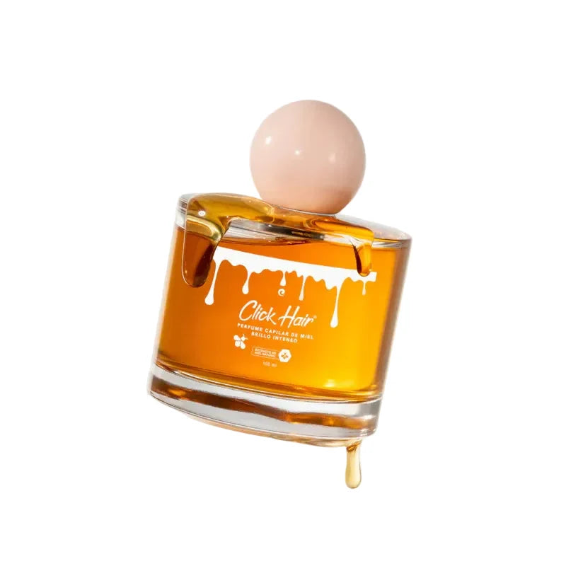 Perfume capilar Click Hair de miel 100 ml, frasco dorado con tapa rosa sobre fondo blanco