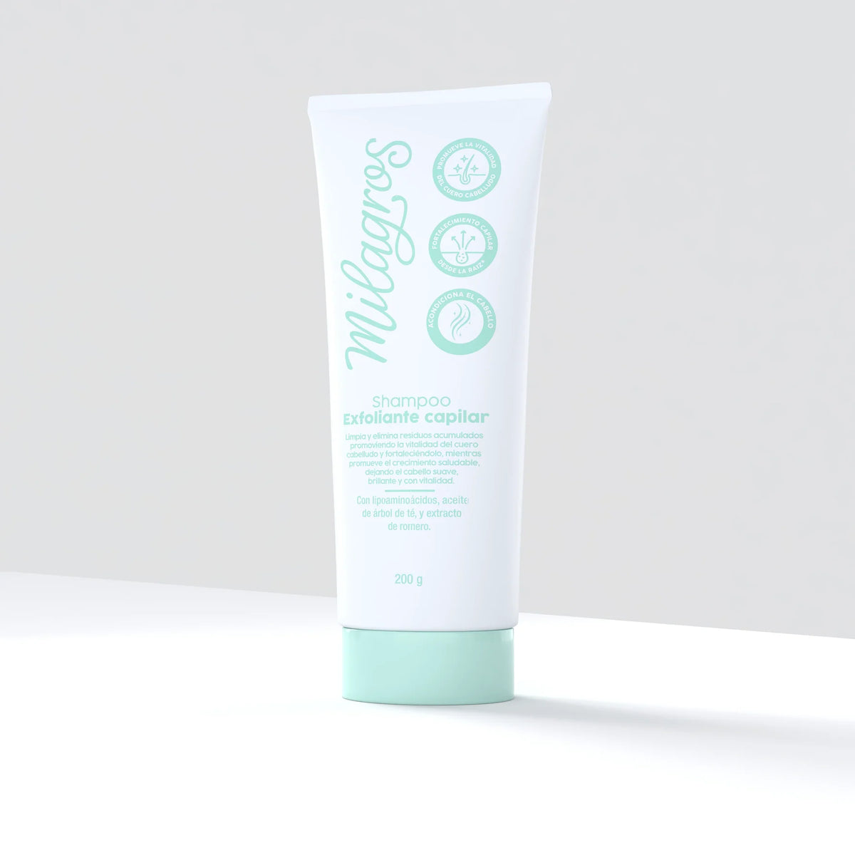Producto recostado → Shampoo Exfoliante Capilar Milagros 200g recostado sobre superficie blanca, empaque blanco con diseño verde menta