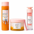 Kit de miel Click Hair con shampoo, mascarilla y miel para el cabello en envases con tapas rosadas sobre fondo blanco.